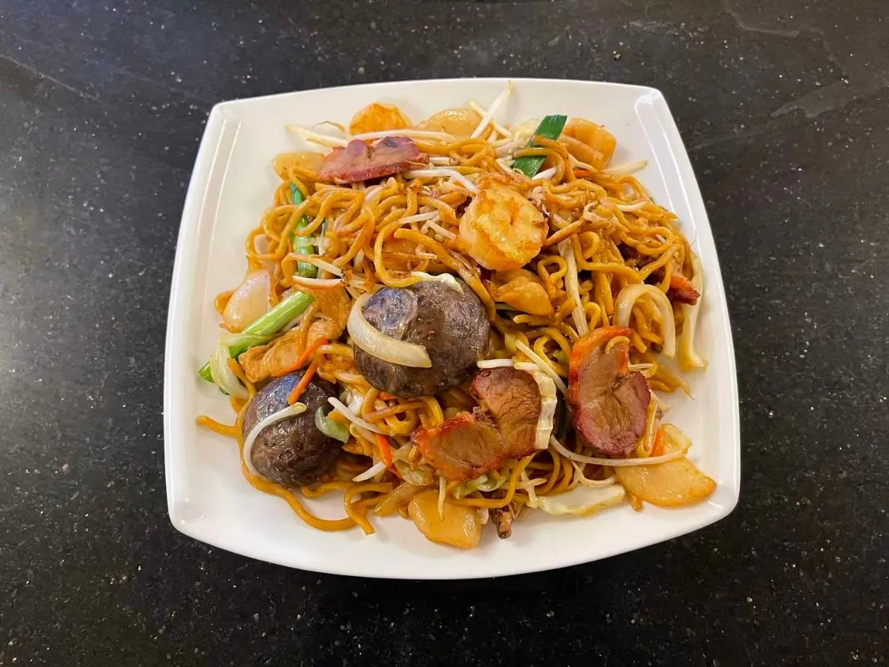 Stir‑fried noodles with shrimp, pork, mushrooms and mixed vegetables