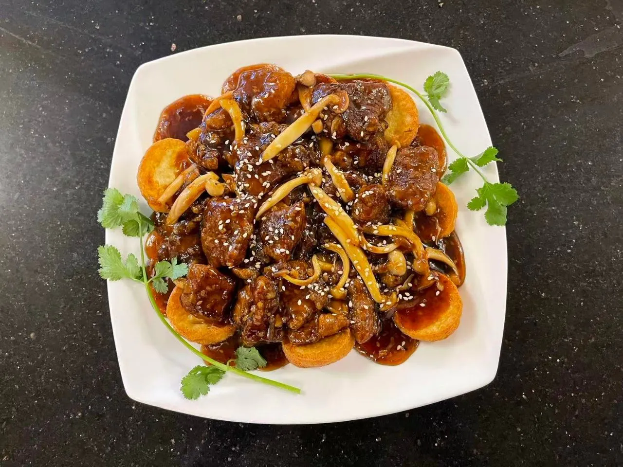 Braised beef with mushrooms, sesame seeds and fried tofu slices